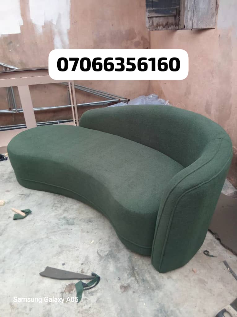 Green curved chaise lounge sofa