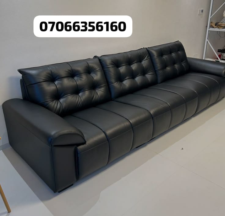 Tufted black leather sofa
